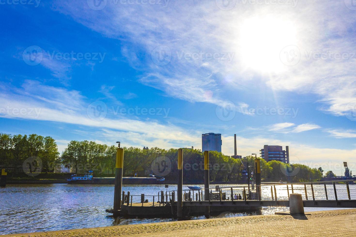 Weser river with dike industry and recreation in Bremen Germany. photo