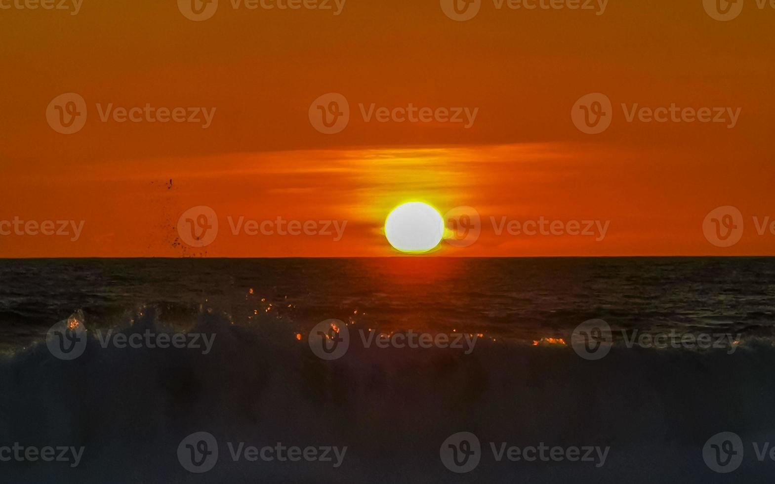 Colorful golden sunset big wave and beach Puerto Escondido Mexico. photo