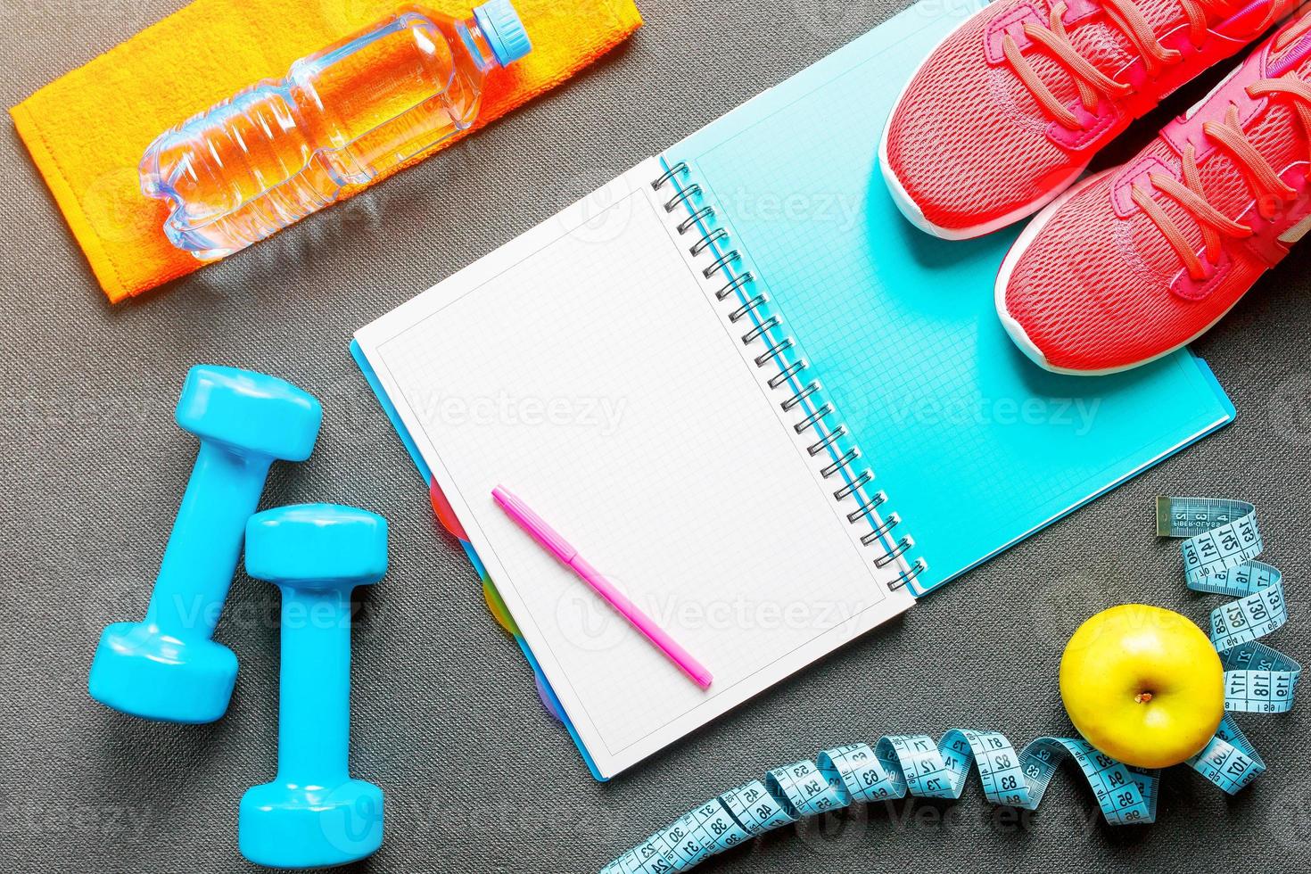 Set of sports accessories for fitness concept with exercise equipment on gray background photo