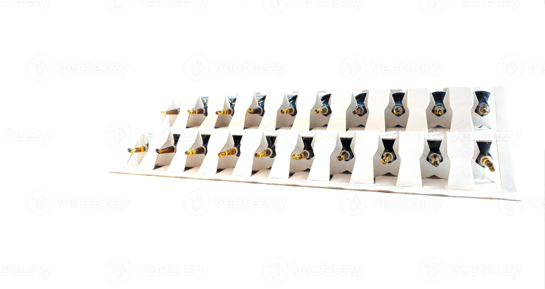 Group of ampoules with a transparent medicine in medical laboratory. lot of ampoules on light background. photo