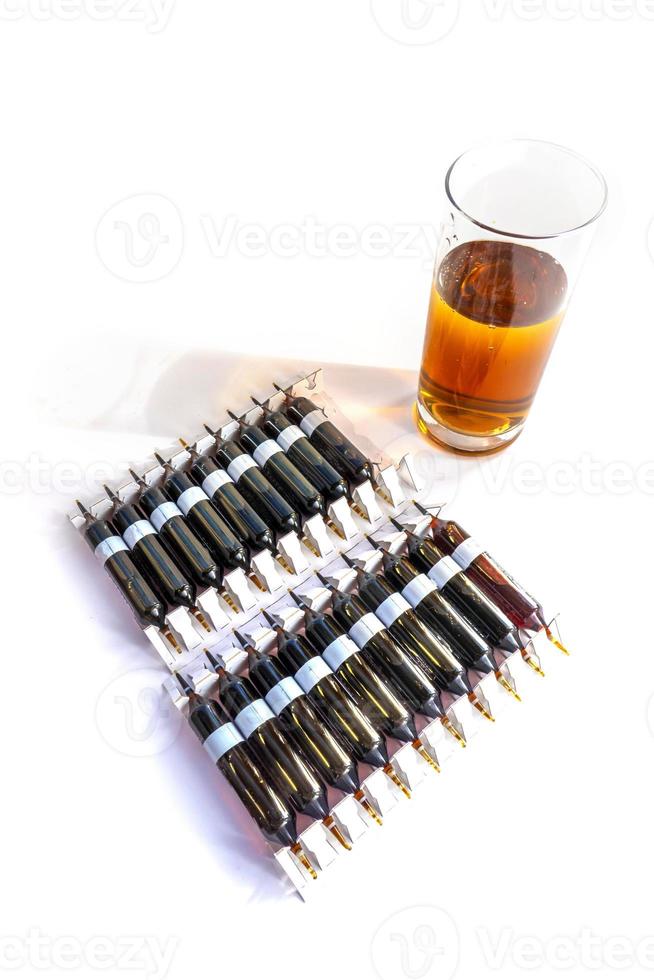 Group of ampoules with a transparent medicine in medical laboratory. lot of ampoules on light background. photo