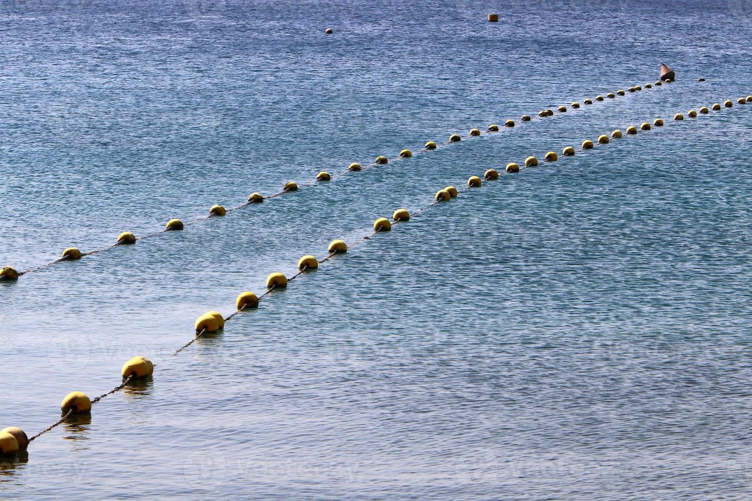 Hemp rope with buoys on the city beach photo