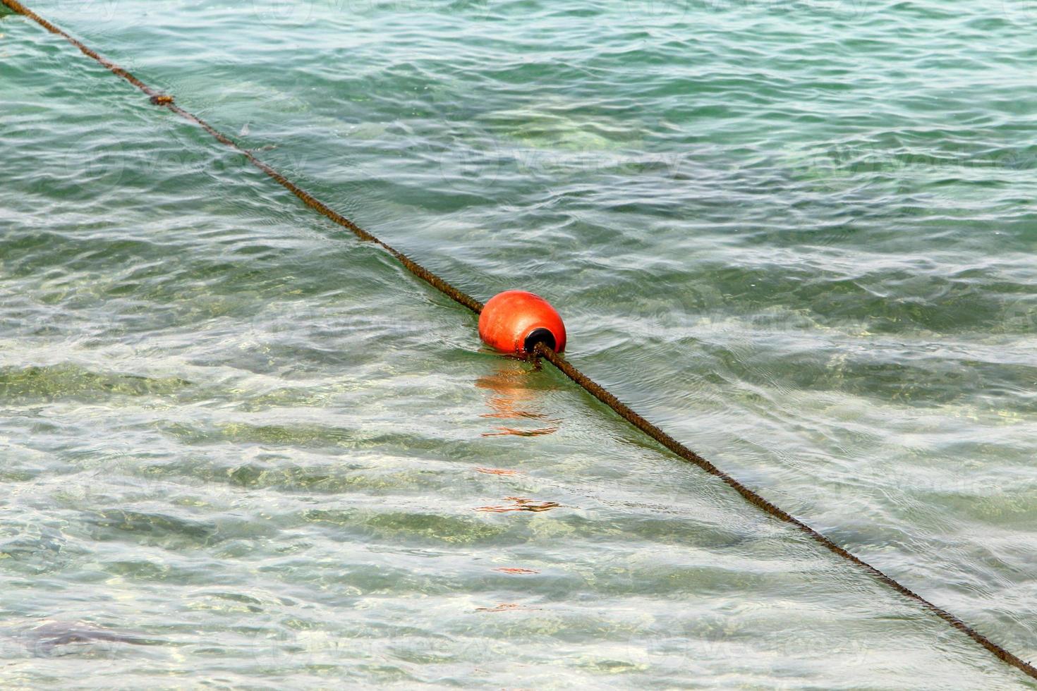 Hemp rope with buoys on the city beach photo