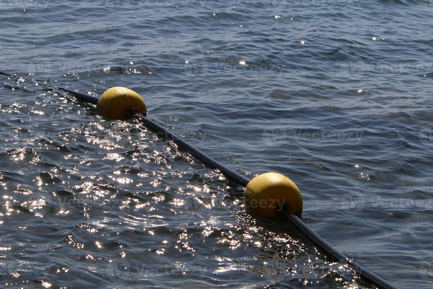 Hemp rope with buoys on the city beach photo