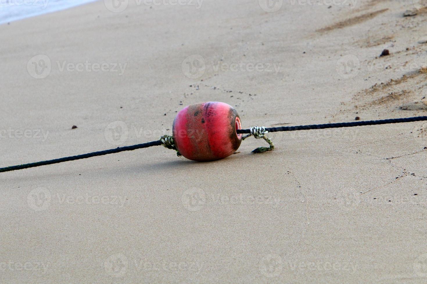 Hemp rope with buoys on the city beach photo