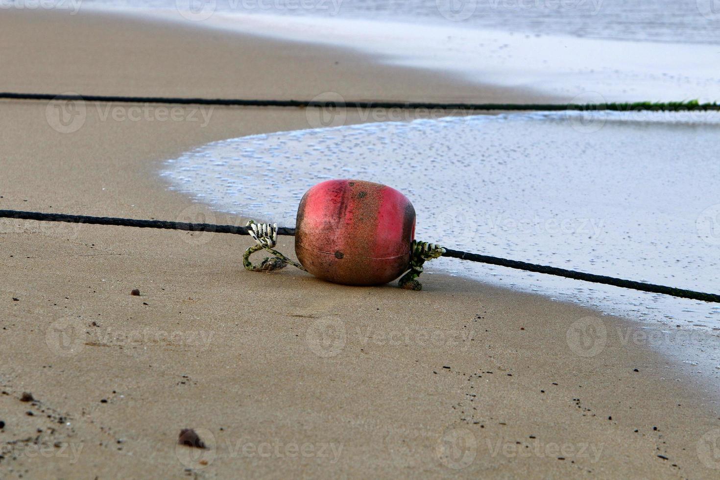 Hemp rope with buoys on the city beach photo