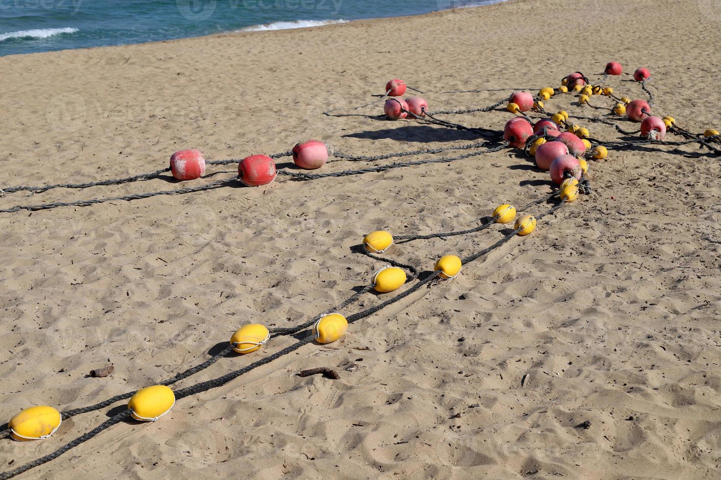 Hemp rope with buoys on the city beach photo