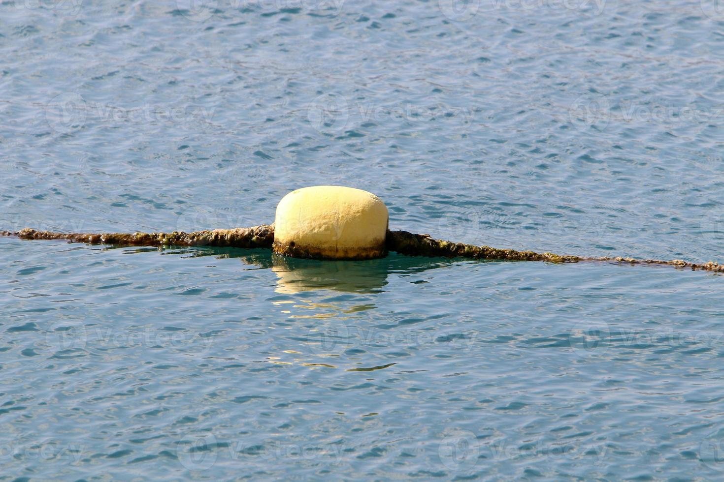 Hemp rope with buoys on the city beach photo