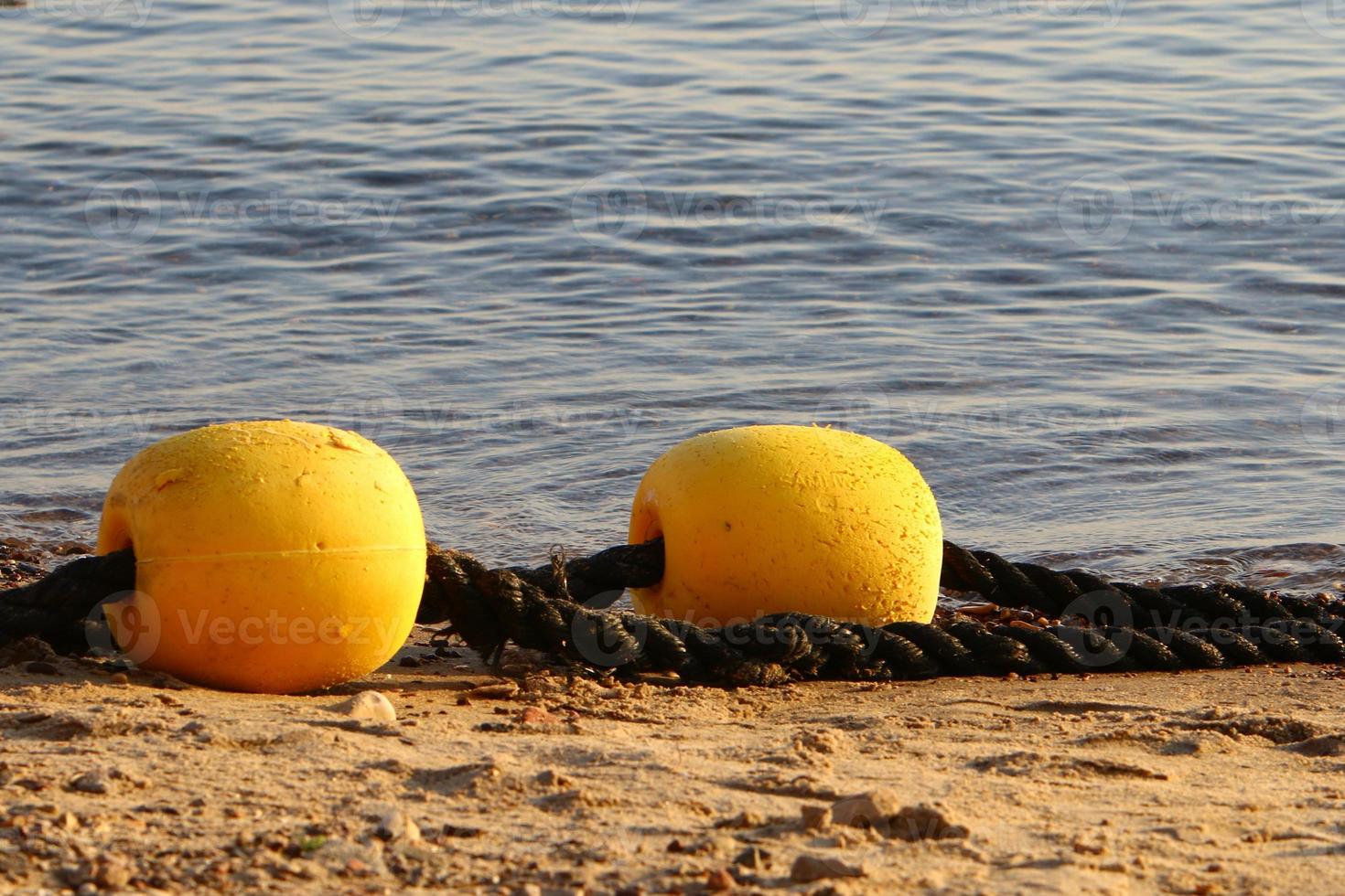 Hemp rope with buoys on the city beach photo