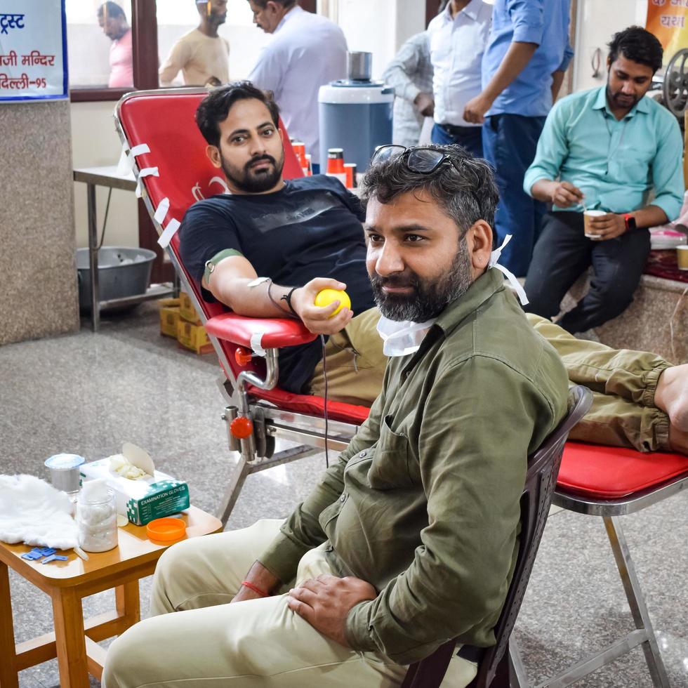 Delhi, India, June 19 2022 - Blood donor at Blood donation camp held at Balaji Temple, Vivek Vihar, Delhi, India, Image for World blood donor day on June 14 every year, Blood Donation Camp at Temple photo