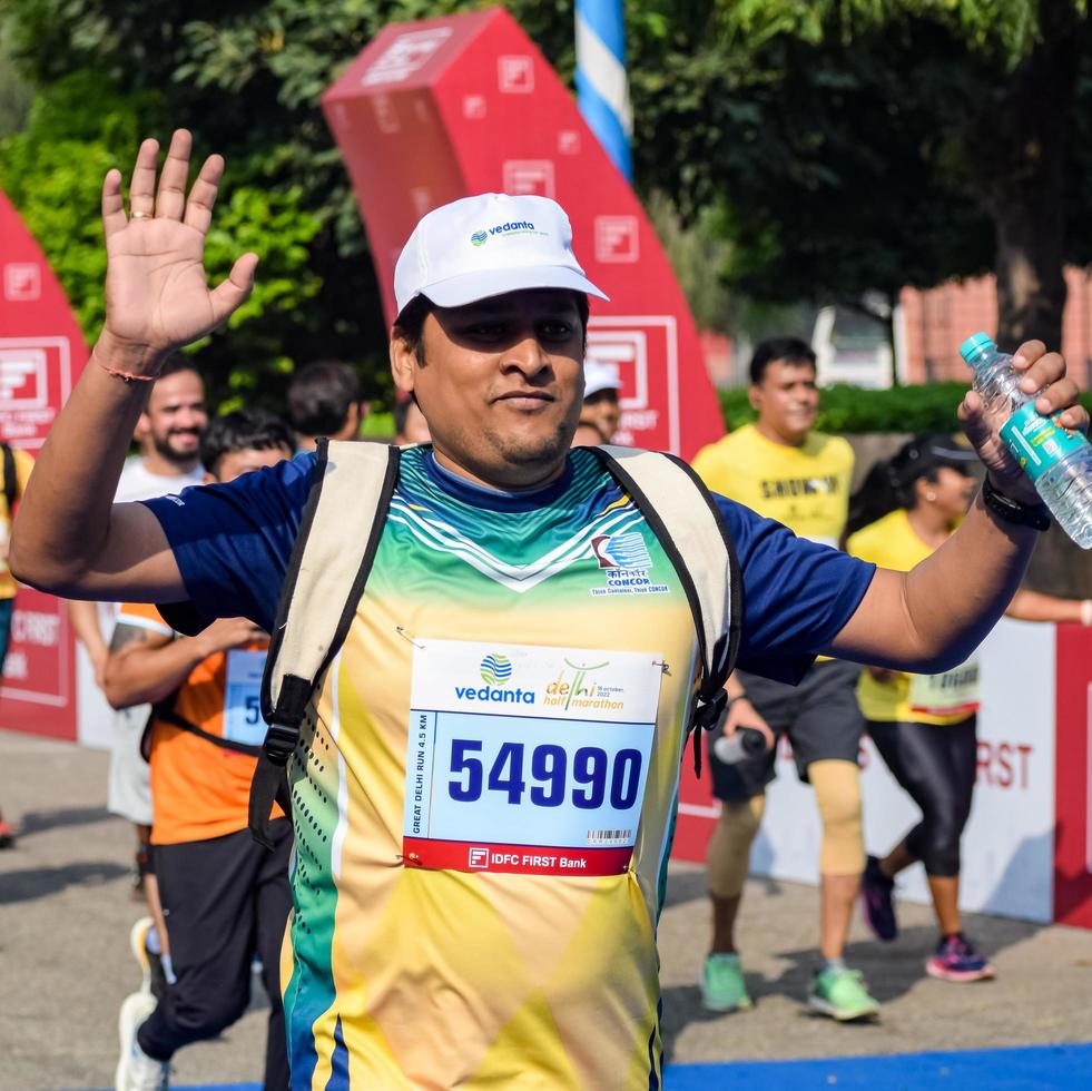New Delhi, India - October 16 2022 - Vedanta Delhi Half Marathon race after covid in which marathon participants about to cross the finish line, Delhi Half Marathon 2022 photo