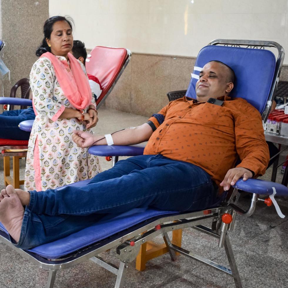 Delhi, India, June 19 2022 - Blood donor at Blood donation camp held at Balaji Temple, Vivek Vihar, Delhi, India, Image for World blood donor day on June 14 every year, Blood Donation Camp at Temple photo