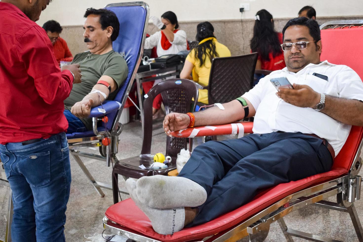 Delhi, India, June 19 2022 - Blood donor at Blood donation camp held at Balaji Temple, Vivek Vihar, Delhi, India, Image for World blood donor day on June 14 every year, Blood Donation Camp at Temple photo