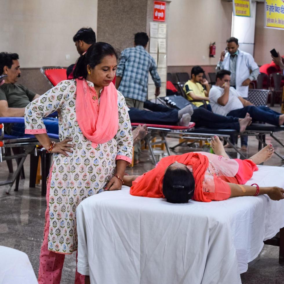 Delhi, India, June 19 2022 - Blood donor at Blood donation camp held at Balaji Temple, Vivek Vihar, Delhi, India, Image for World blood donor day on June 14 every year, Blood Donation Camp at Temple photo