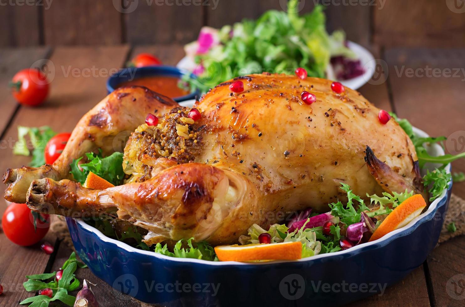 Baked chicken stuffed with rice for Christmas dinner on a festive table photo
