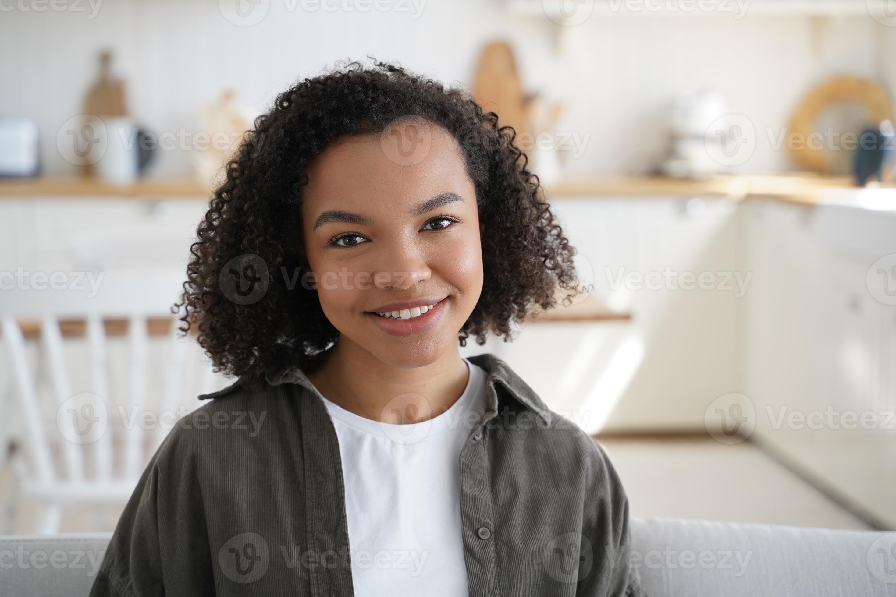 Friendly smiling young pretty mixed race girl with afro hairstyle