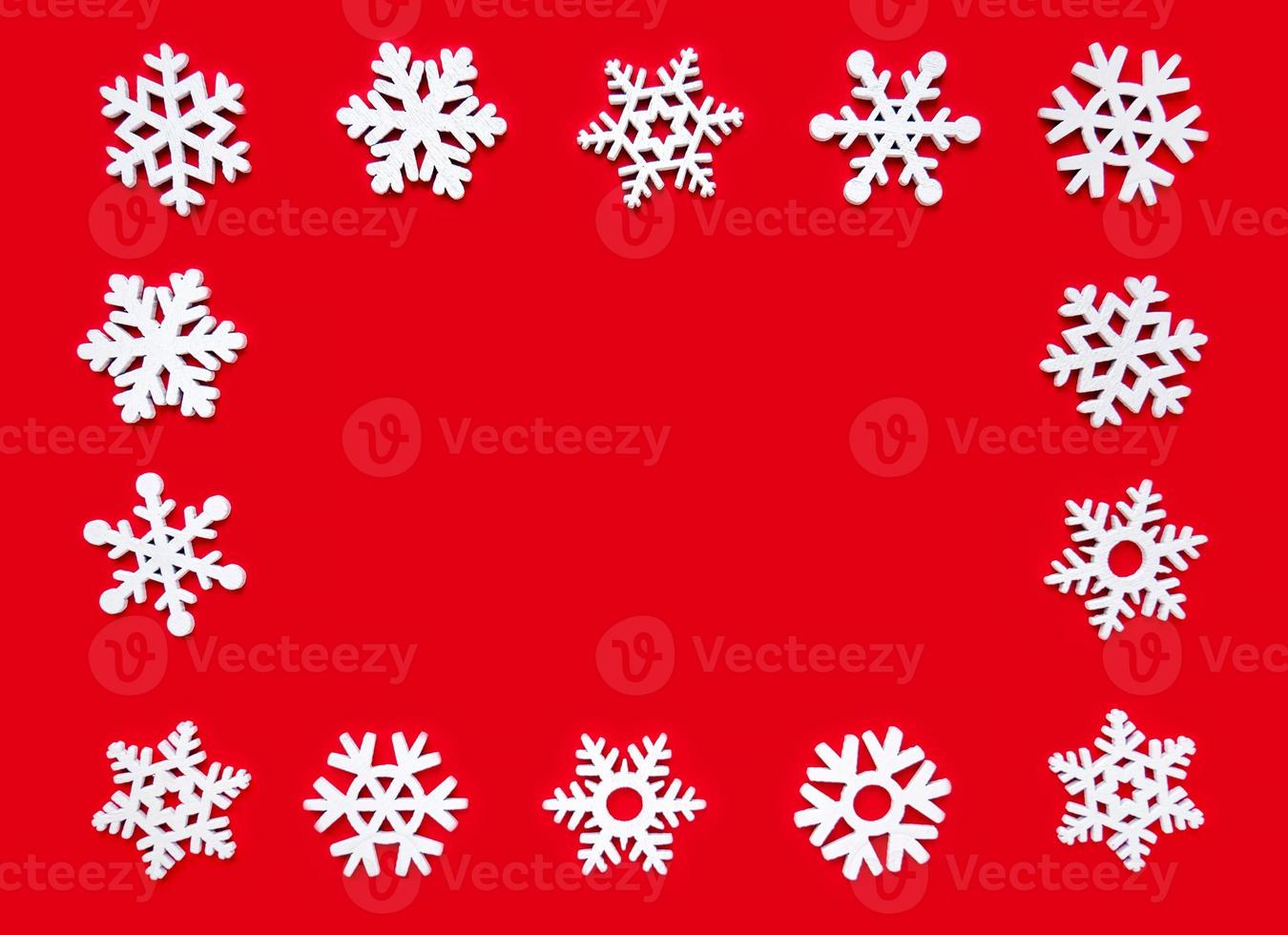 Snowflake frame on a red background, Christmas holiday composition top view, copy space photo