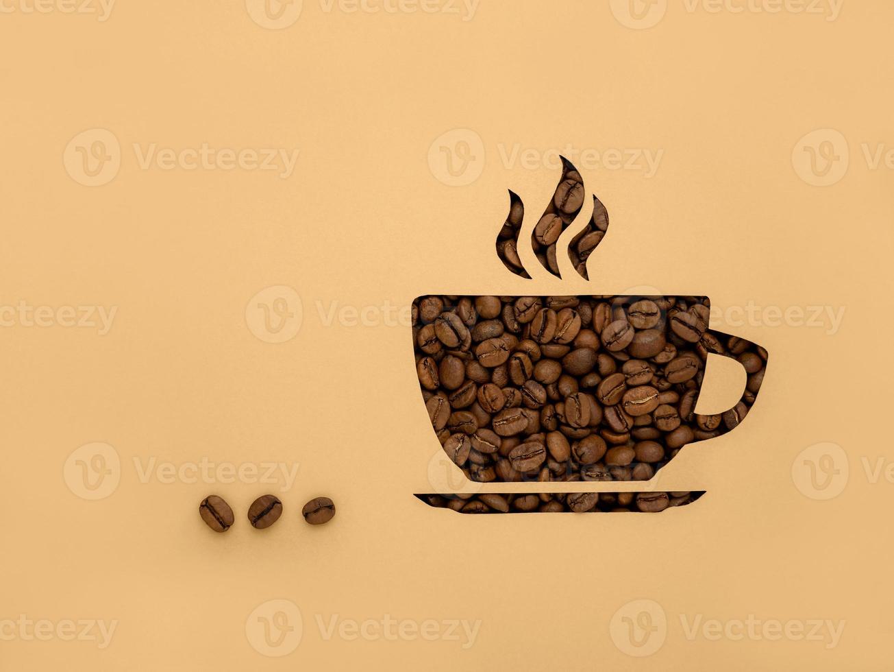 The symbol Is a Cup of black aromatic coffee beans. Paper background, cut out, with copy of the space and space for text photo