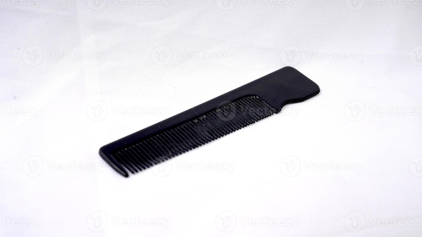 Black comb isolated on a white background. Top view photo