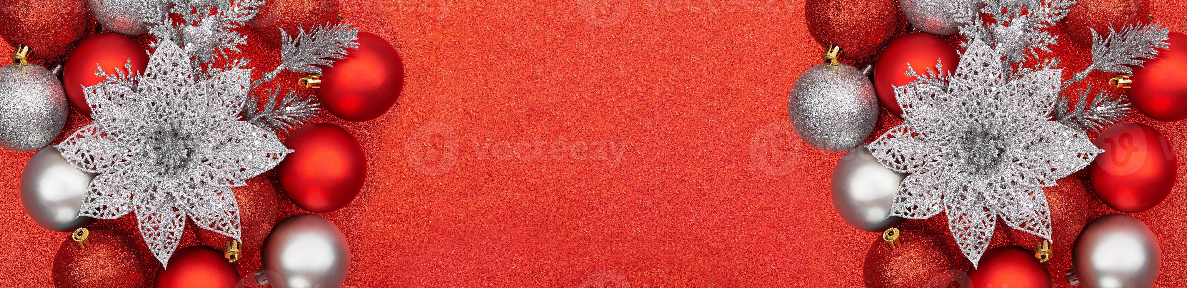 Red, silver Christmas balls and flowers on shiny background. New Year. Banner. Copy space photo