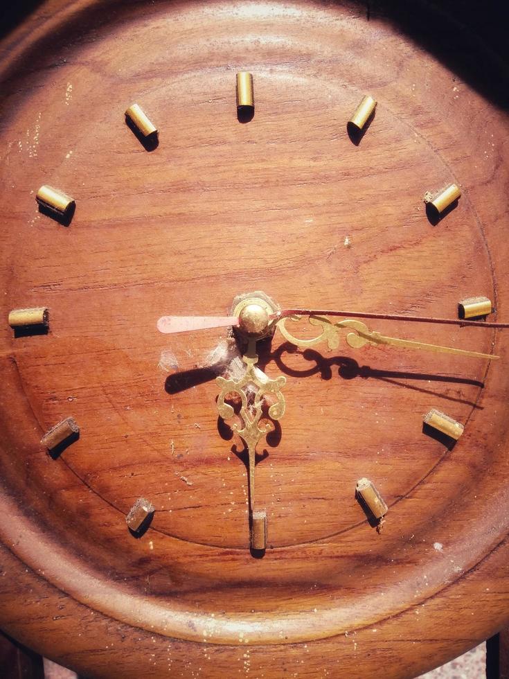 Analog wall clock made of wood has an old or vintage feel photo