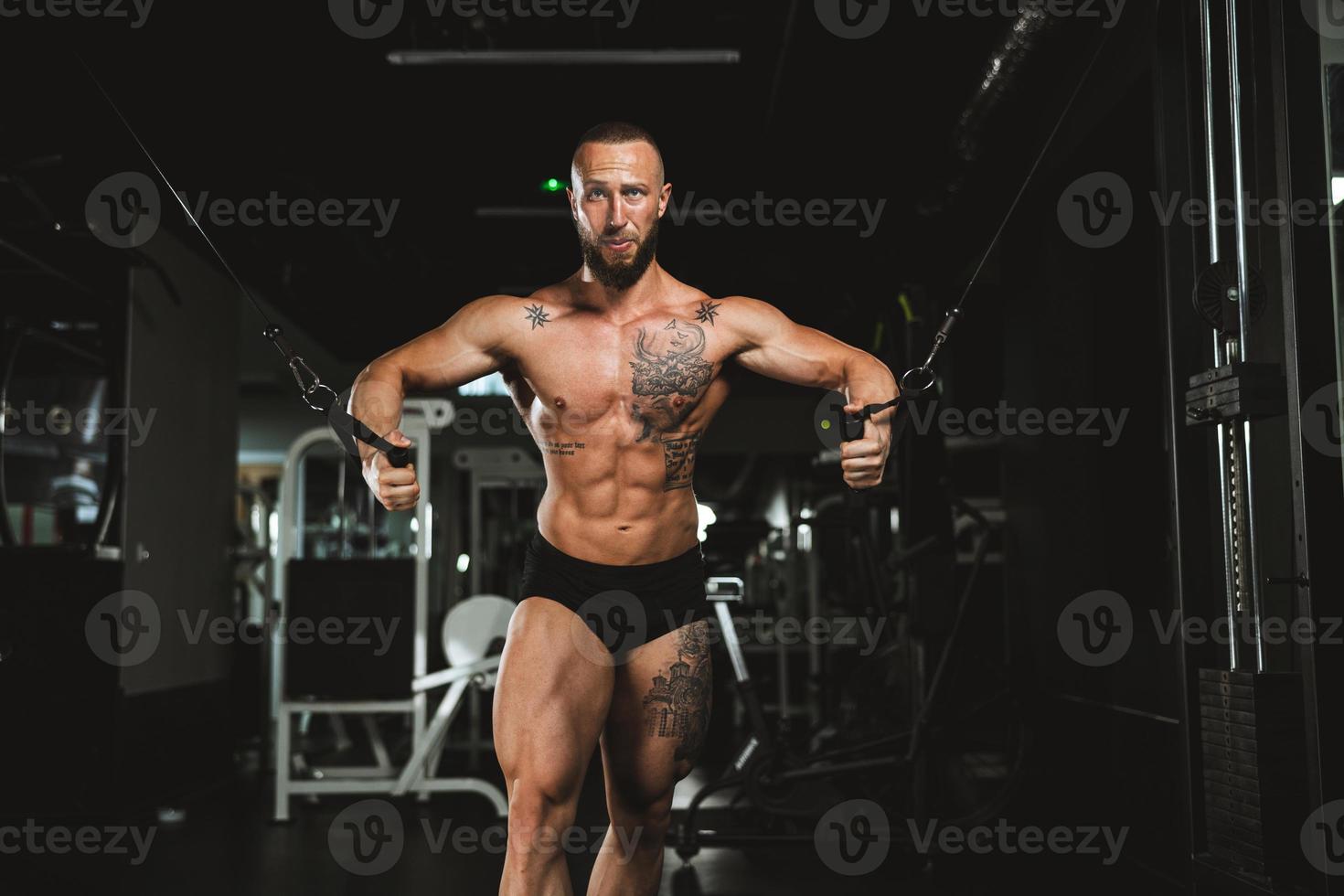 Man Doing Training On Machine For His Chest Muscle At The Gym photo