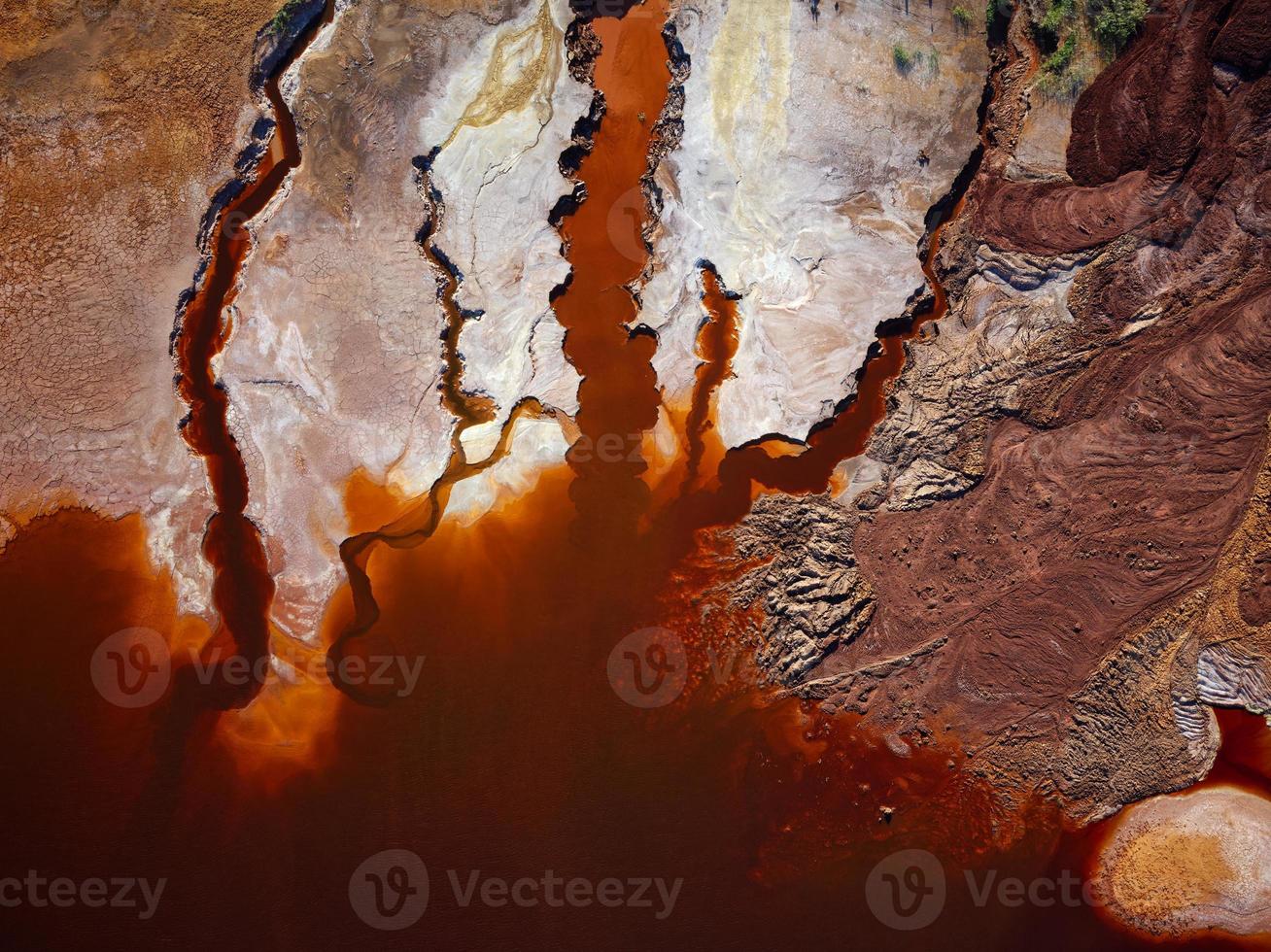 Aerial drone view of Mining activity in Minas de Riotinto in Spain. Polluted lake, red color of water. Apocalypse scenery. Extractivism. Mining village in Andalusia. Earth destruction. Disruption. photo