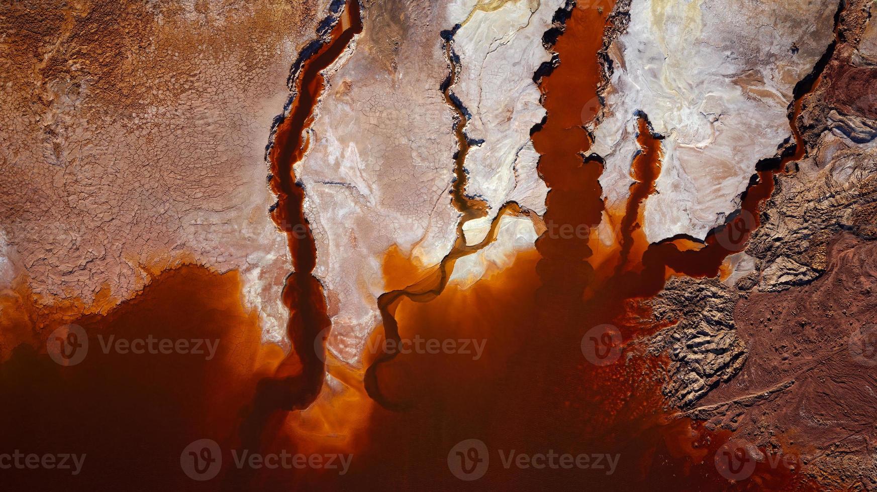 Aerial drone view of Mining activity in Minas de Riotinto in Spain. Polluted lake, red color of water. Apocalypse scenery. Extractivism. Mining village in Andalusia. Earth destruction. Disruption. photo