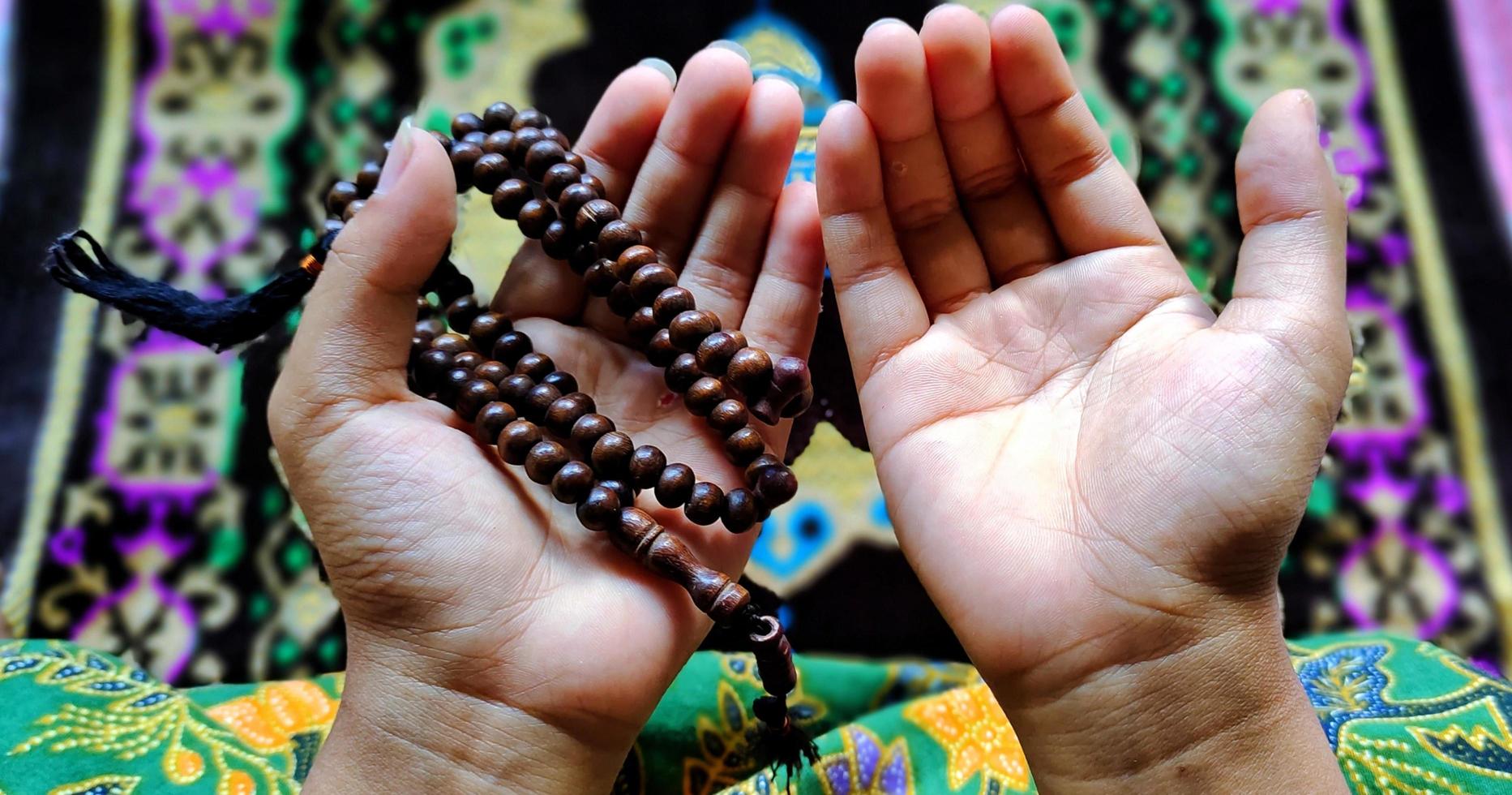 Muslim praying with tasbih photo
