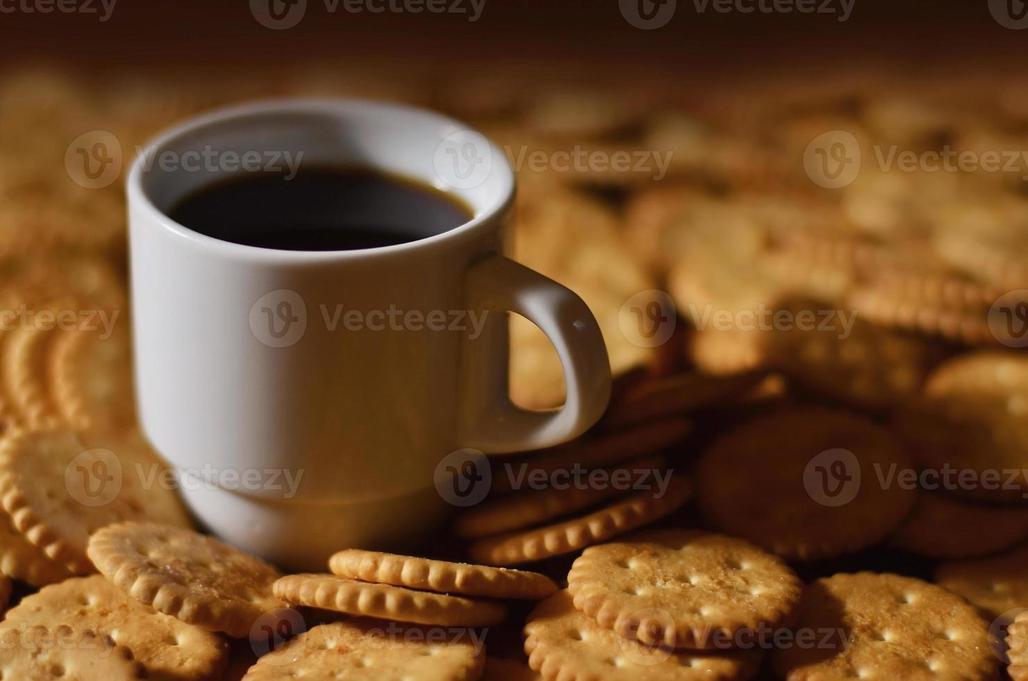 Small coffee cup and salted cracker photo