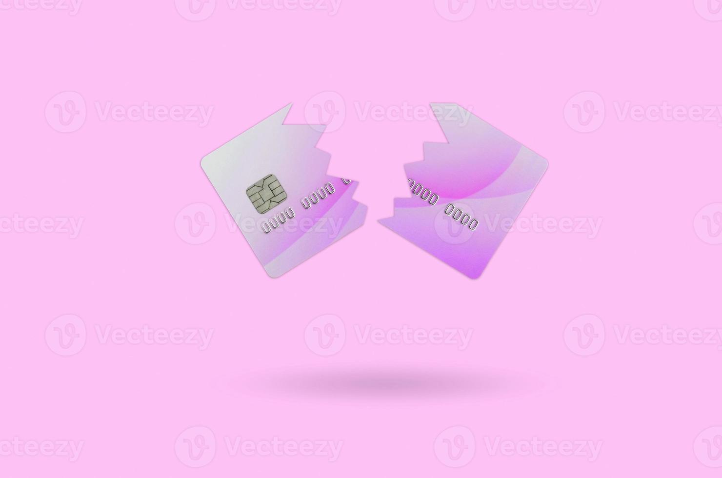 Cut broken pink credit card isolated on orange photo