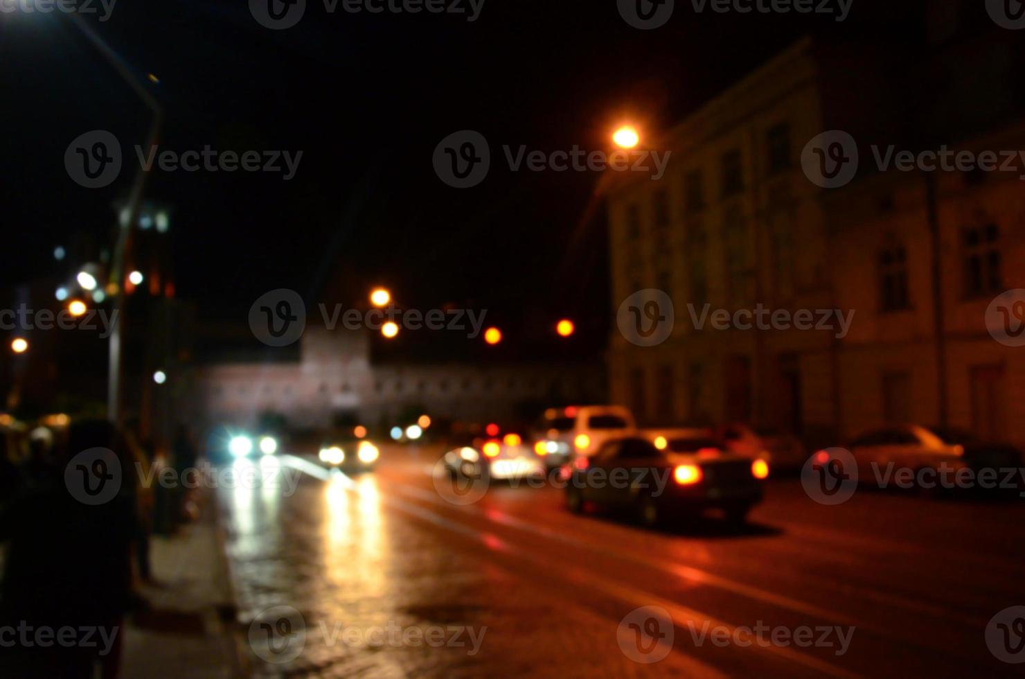 Blurred night scene of traffic on the roadway. Defocused image of cars traveling with luminous headlights. Bokeh Art photo