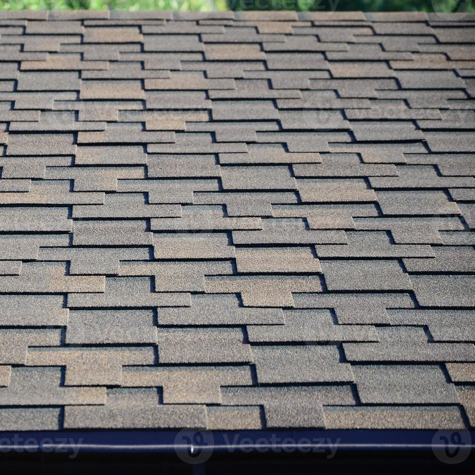 Modern roofing and decoration of chimneys. Flexible bitumen or slate shingles photo