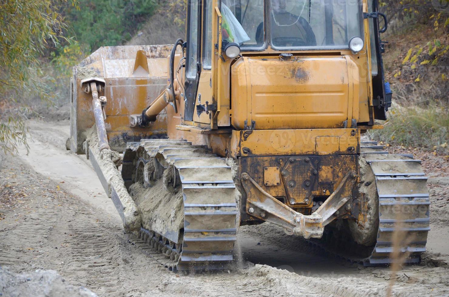Quarry aggregate with heavy duty machinery. Caterpillar loader Excavator with backhoe driving to construction site quarry photo