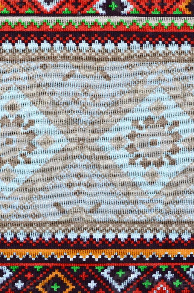 Traditional Ukrainian folk art knitted embroidery pattern on textile fabric photo