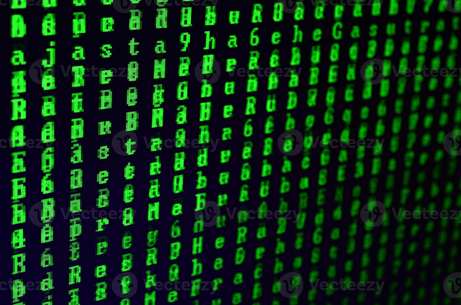 Macro shot of a glitch on the monitor of an office computer. The concept of introducing a virus into a personal data keeper. Stream of random green symbols on a black background photo