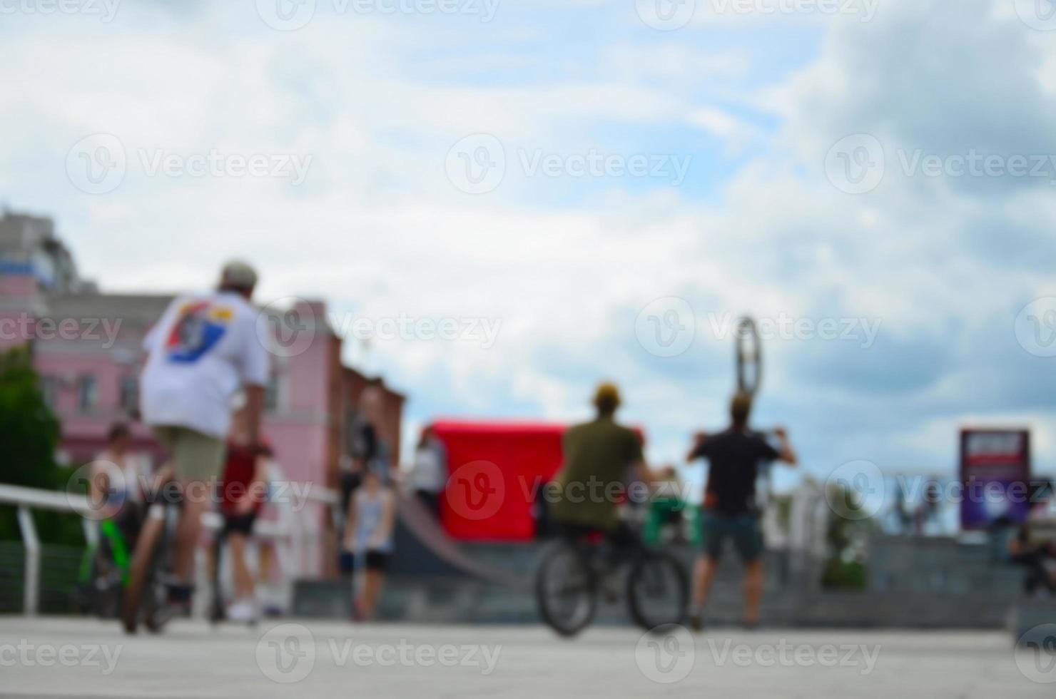 Defocused image of a lot of people with bmx bikes. Meeting of fans of extreme sports photo