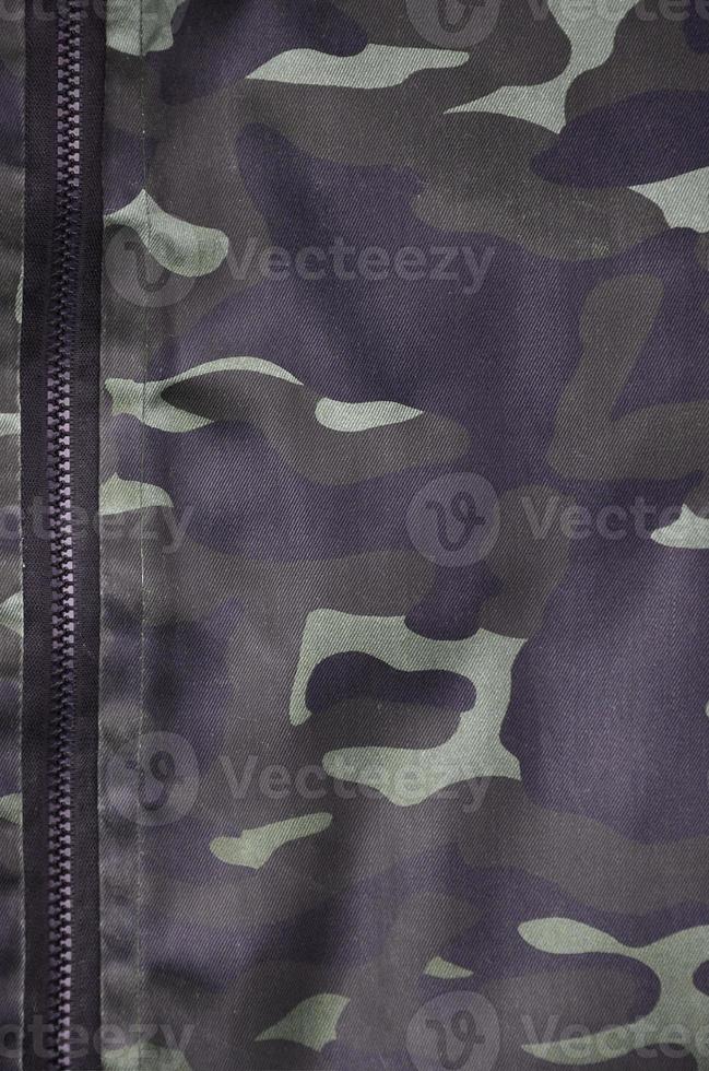 Texture of fabric with a camouflage painted in colors of the marsh. Army background image photo