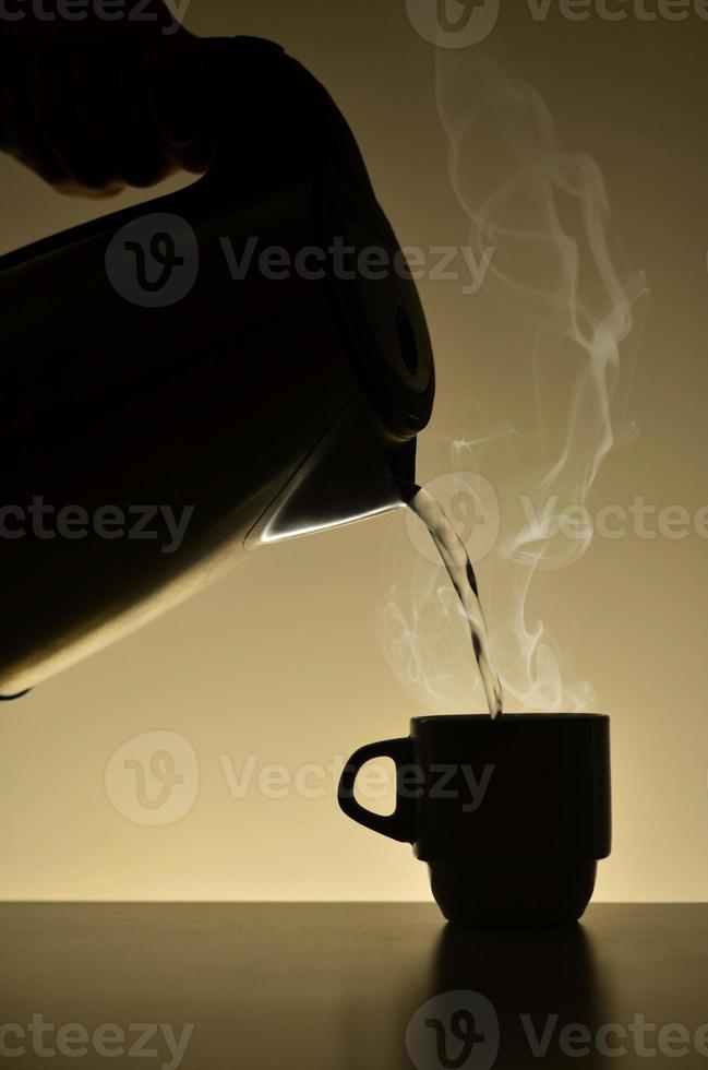Teapot and cup of coffee photo