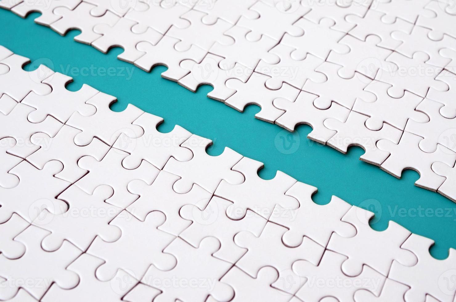 The blue path is laid on the platform of a white folded jigsaw puzzle. Texture image with copy space for text photo