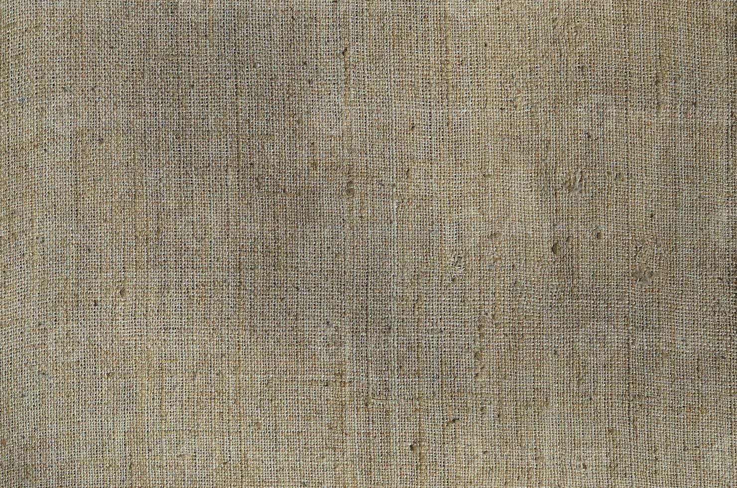 Texture of a gray canvas made of old and coarse burlap. Top view photo