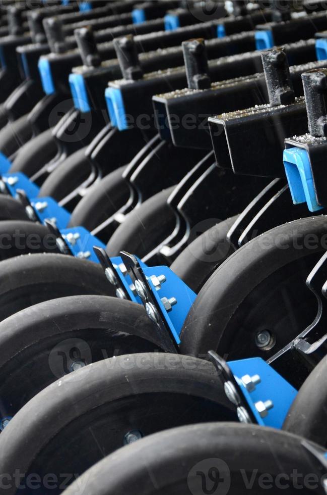 Row of wheels of the new industrial agricultural seeder close up photo