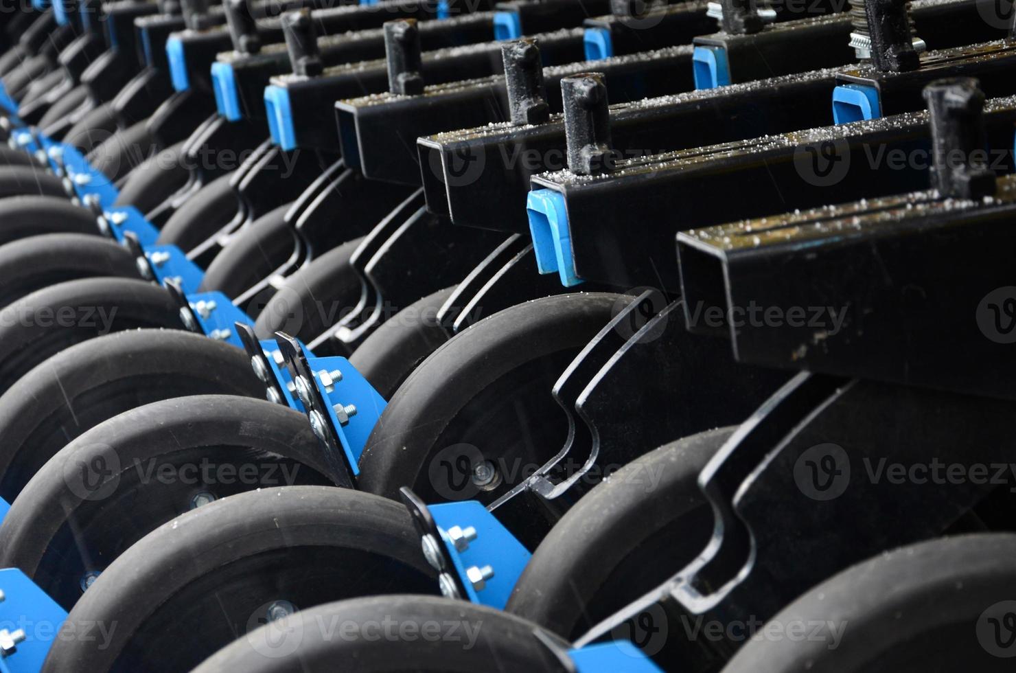 Row of wheels of the new industrial agricultural seeder close up photo