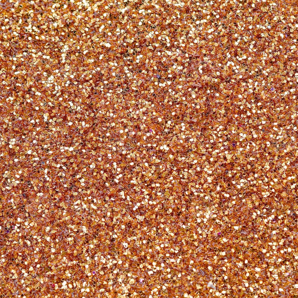 Orange decorative sequins. Background image with shiny bokeh lights from small elements photo
