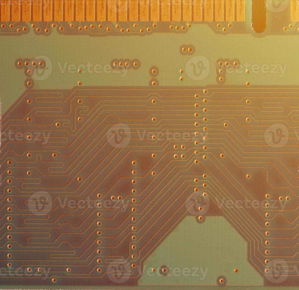 A toned macro image of a computer board with many small technological elements. Extremely shallow depth of field. Abstract technological background photo