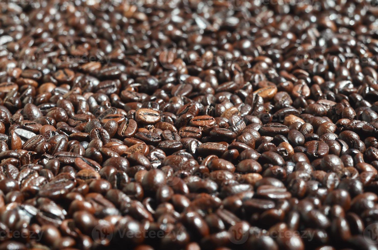 Background texture of a huge number of fragrant and fresh brown roasted coffee grains photo