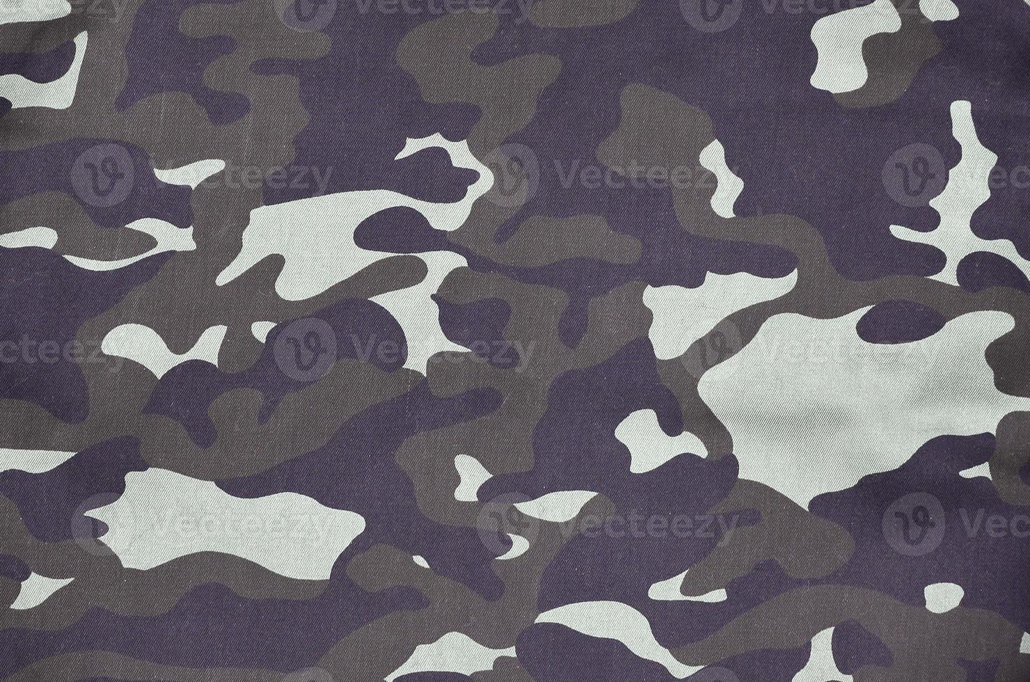 Texture of fabric with a camouflage painted in colors of the marsh. Army background image photo