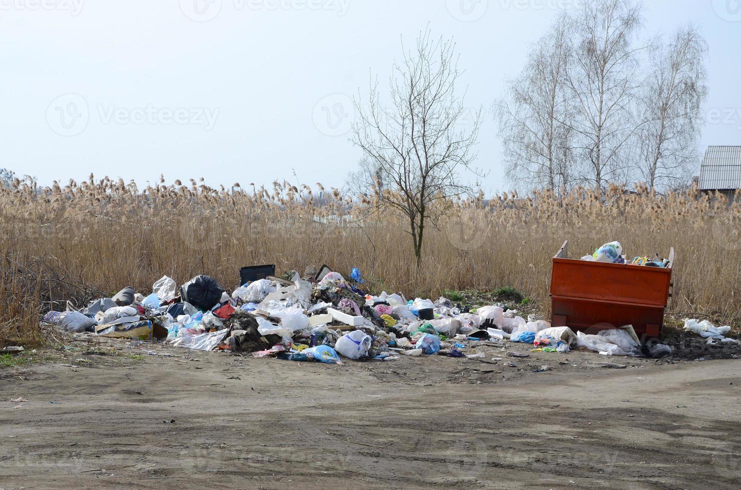 The garbage can is packed with garbage and waste. Untimely removal of garbage in populated areas photo