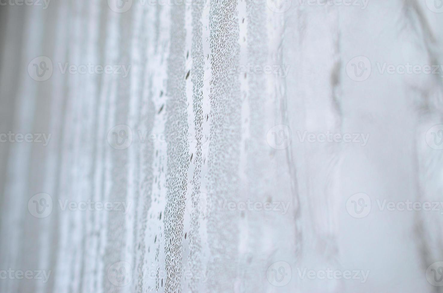 The texture of a misted glass with a lot of drops and condensation flows. Background image photo