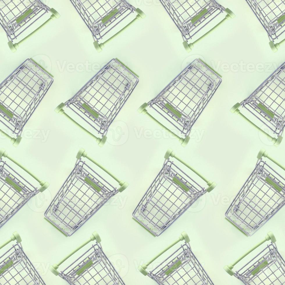 Pattern of many small shopping carts on a lime background photo